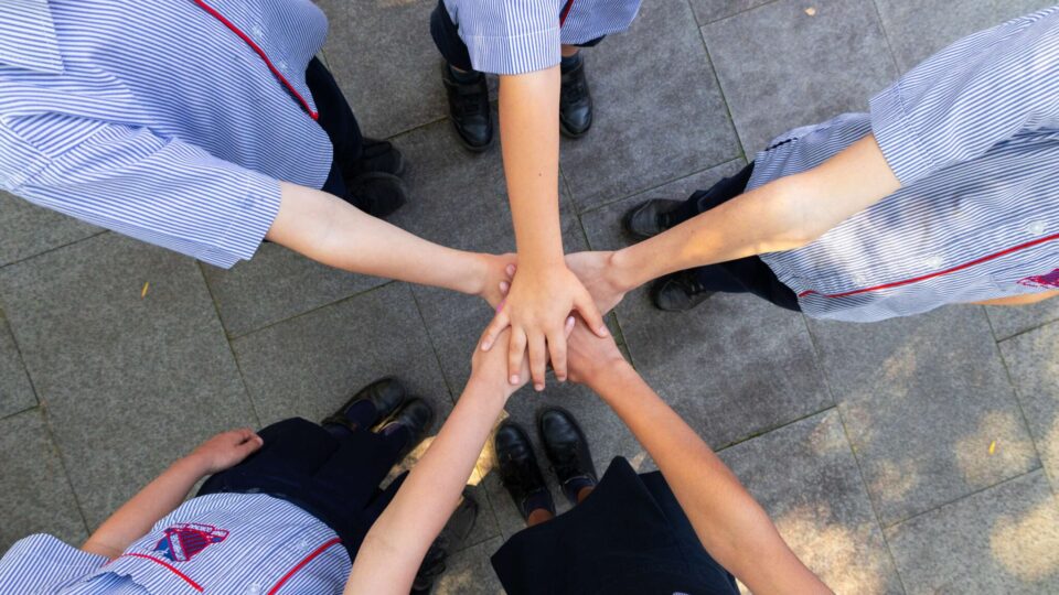 Students hands linked